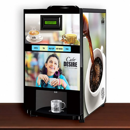 A Cafe Desire brand coffee dispenser machine with a black frame and colorful printed graphics showing coffee cups, a woman smiling, and coffee being poured into a cup, set on a wooden surface against a white background.